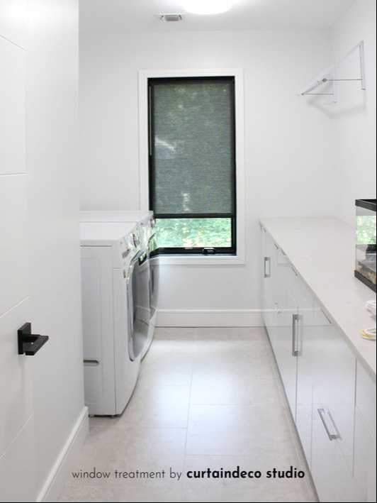 Laundry room in Closter, NJ featuring a window with a roller shade, providing a clean and functional design.